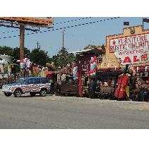 A jeep with American flag design parked in front of a furniture store with a large 
