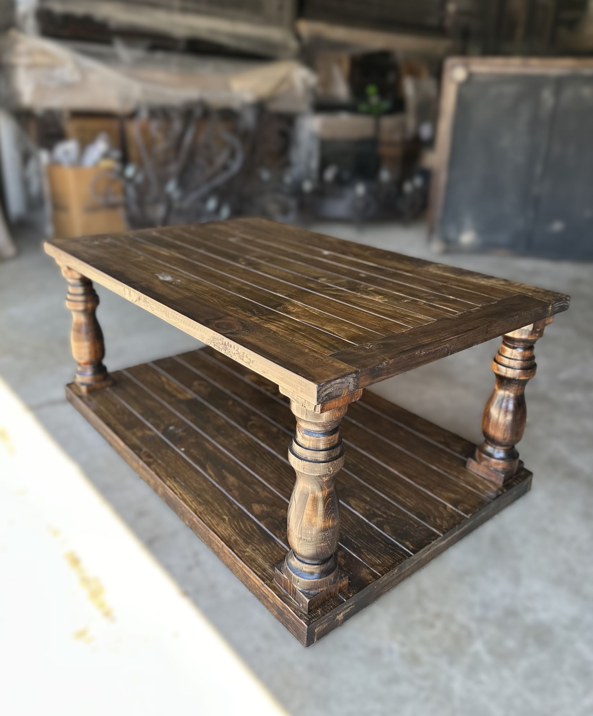 Rustic brown wooden coffee table with turned legs and a lower shelf.
