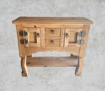 Wooden cabinet with two drawers and two doors, ornate metal hinges and handles, lower shelf, light brown.