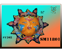 A colorful, ceramic sun face with radiating rays against a gradient background.