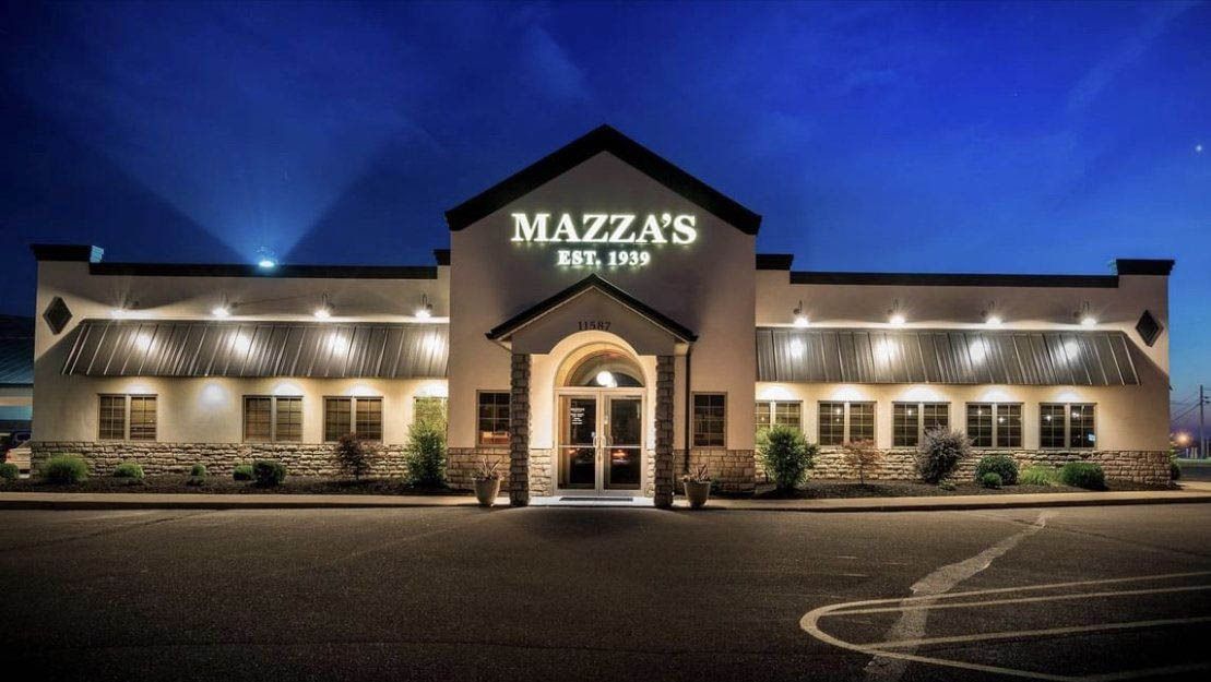 A mazza 's restaurant is lit up at night