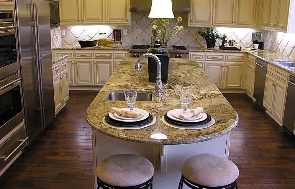 A kitchen with granite counter tops and stainless steel appliances