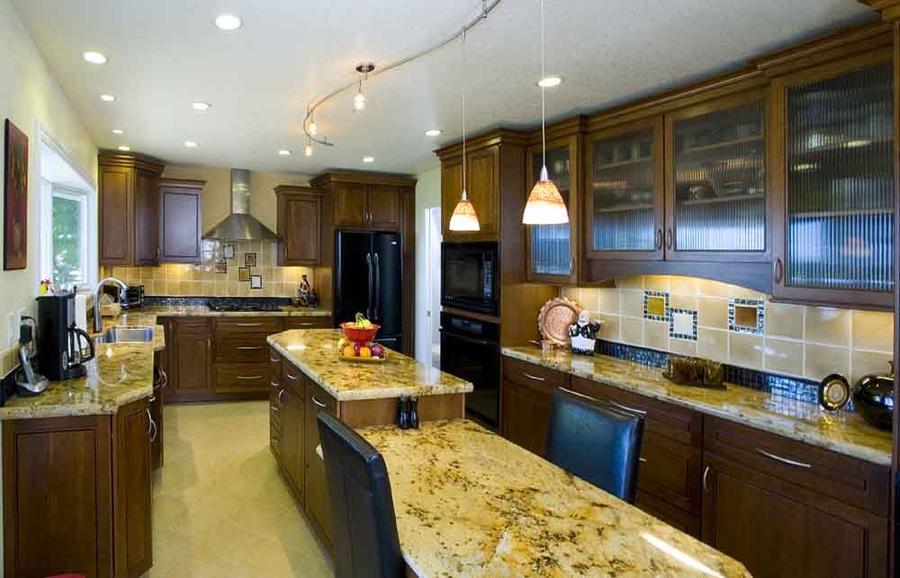 A kitchen with granite counter tops and wooden cabinets