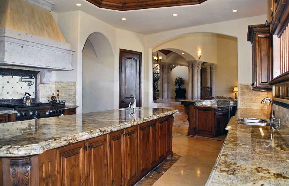 A kitchen with granite counter tops and wooden cabinets