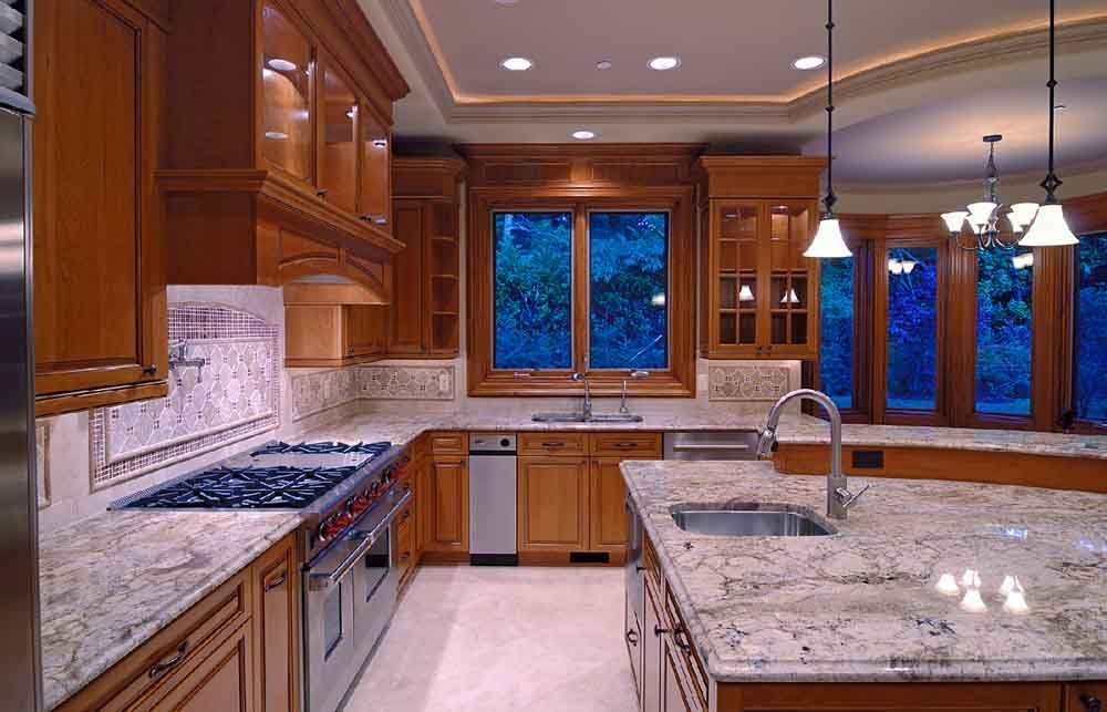 A kitchen with granite counter tops and wooden cabinets