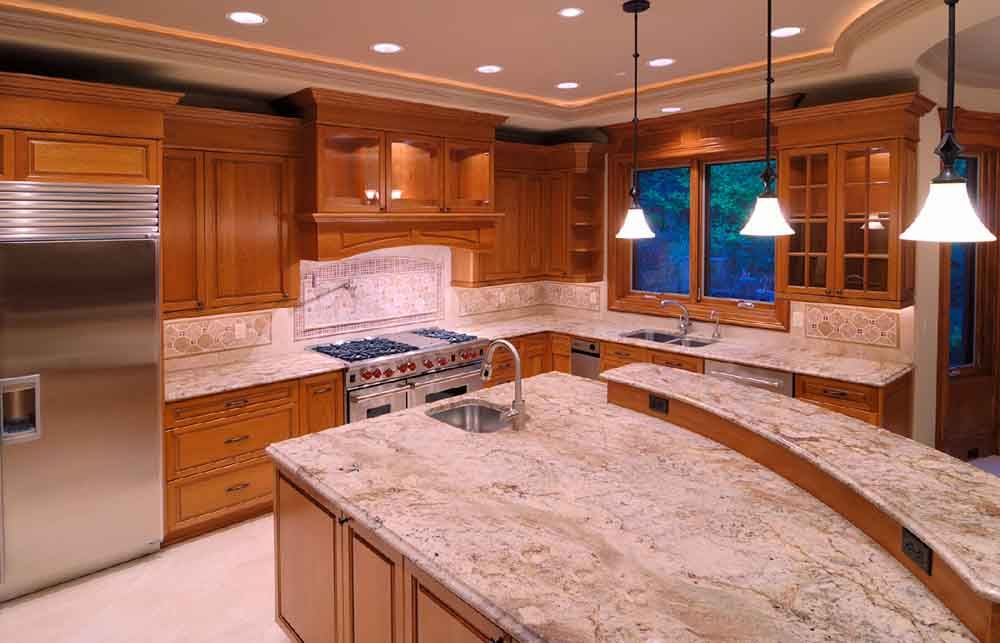 A kitchen with granite counter tops and stainless steel appliances.