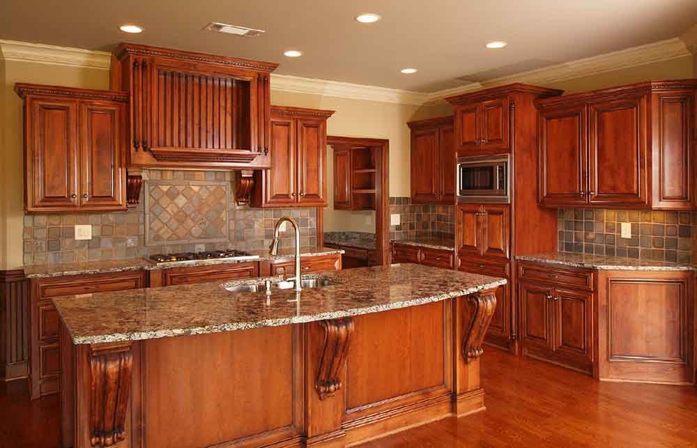 A large kitchen with wooden cabinets and granite counter tops.