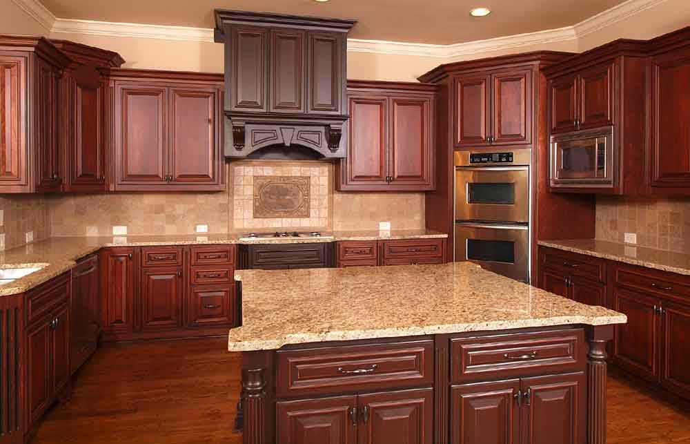 A kitchen with wooden cabinets and granite counter tops