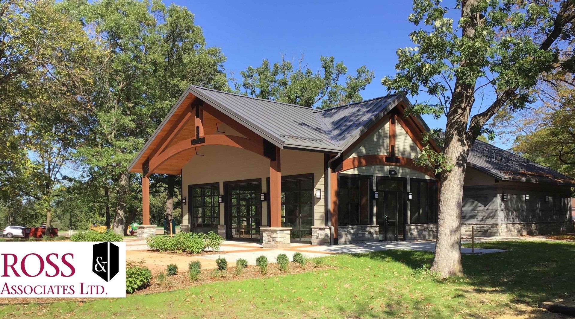 A large house with a roof that is surrounded by trees.