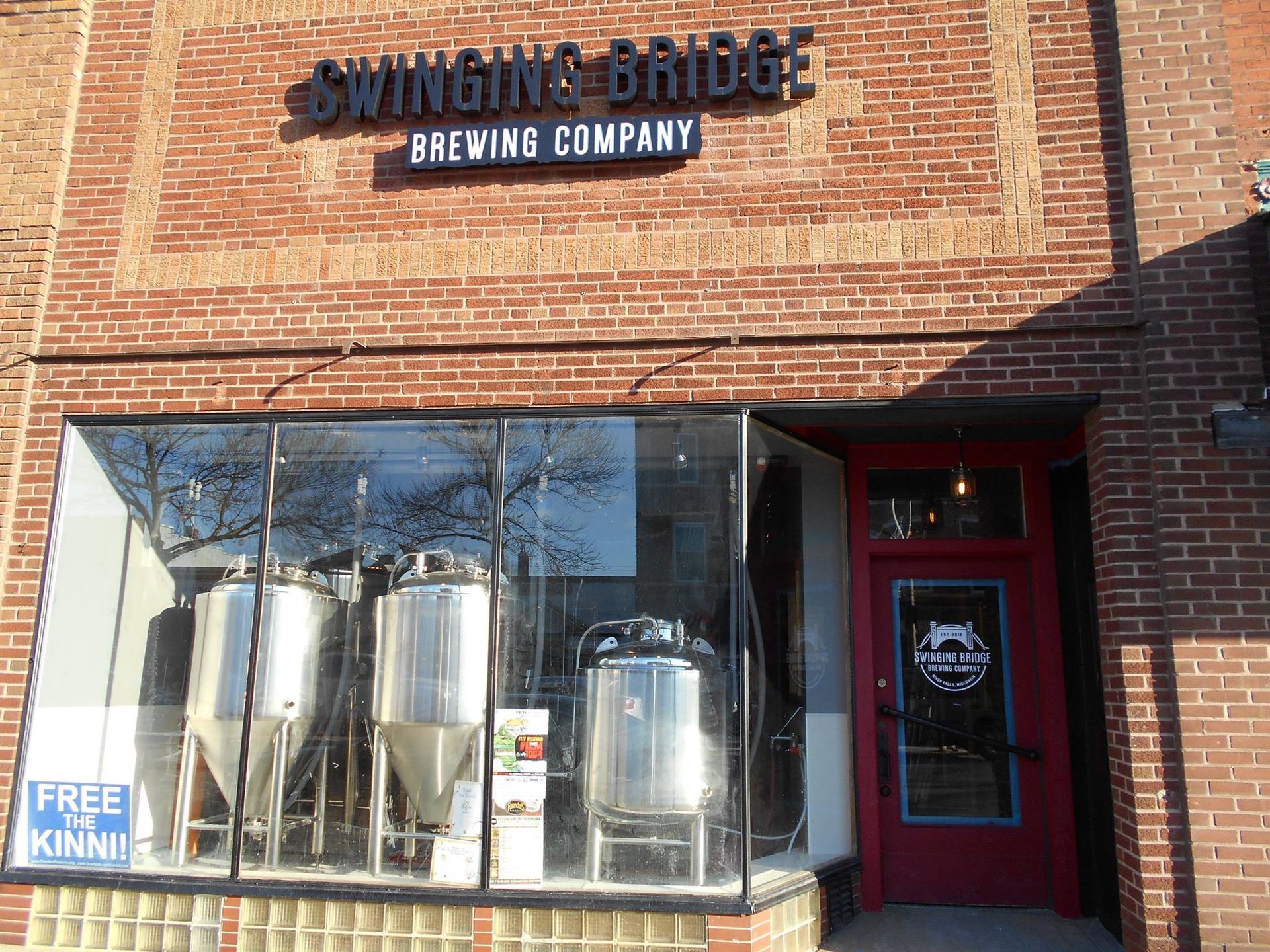 The swinging bridge brewing company is located in a brick building