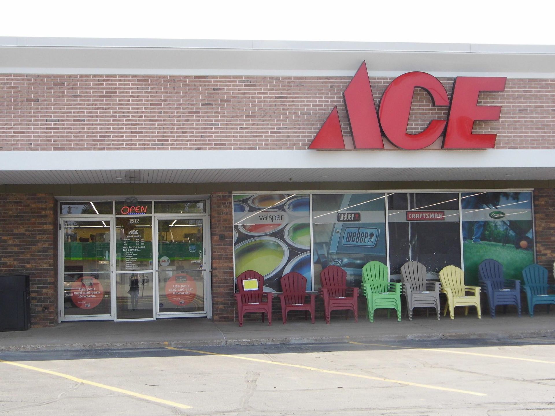 An ace hardware store with a lot of chairs in front of it