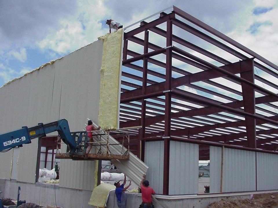 A building under construction with a crane that says a305-b on it