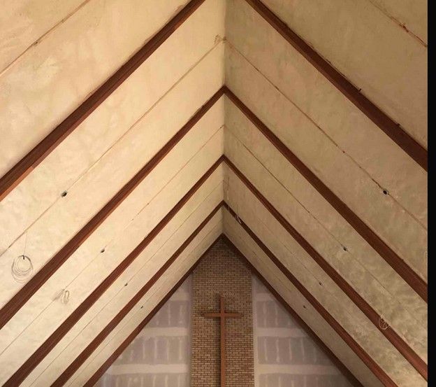 A wooden cross is in the corner of a church