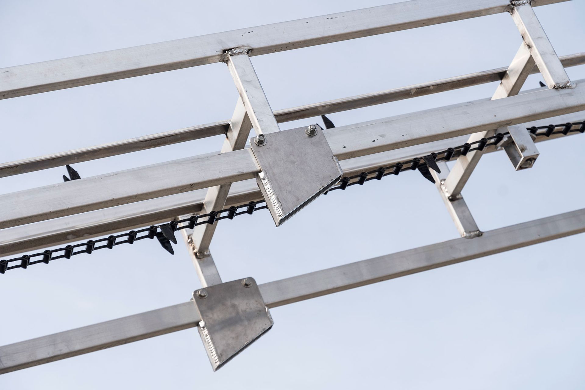 A close up of a metal structure with a chain attached to it.