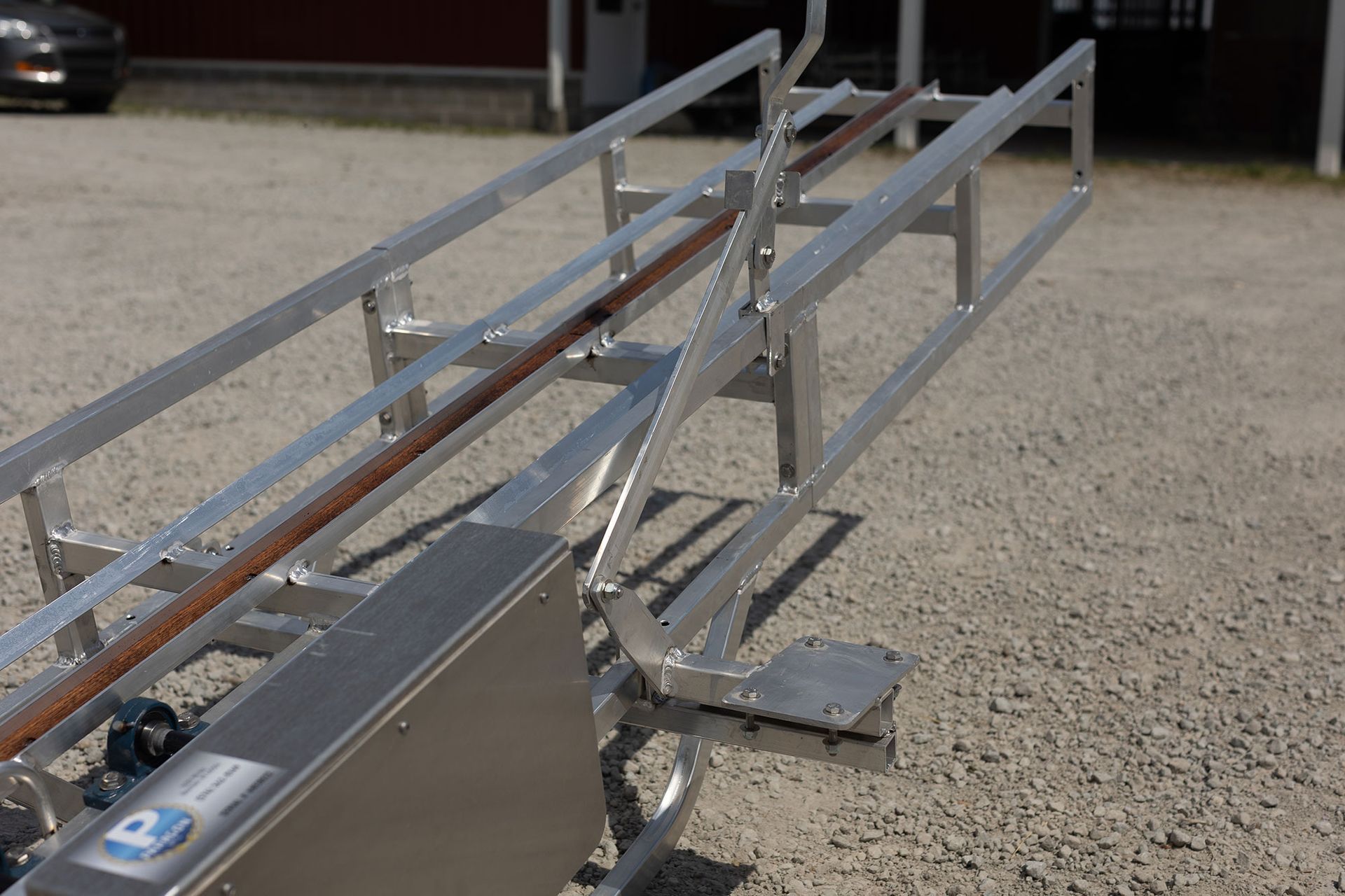 A stainless steel conveyor belt with the letter p on it