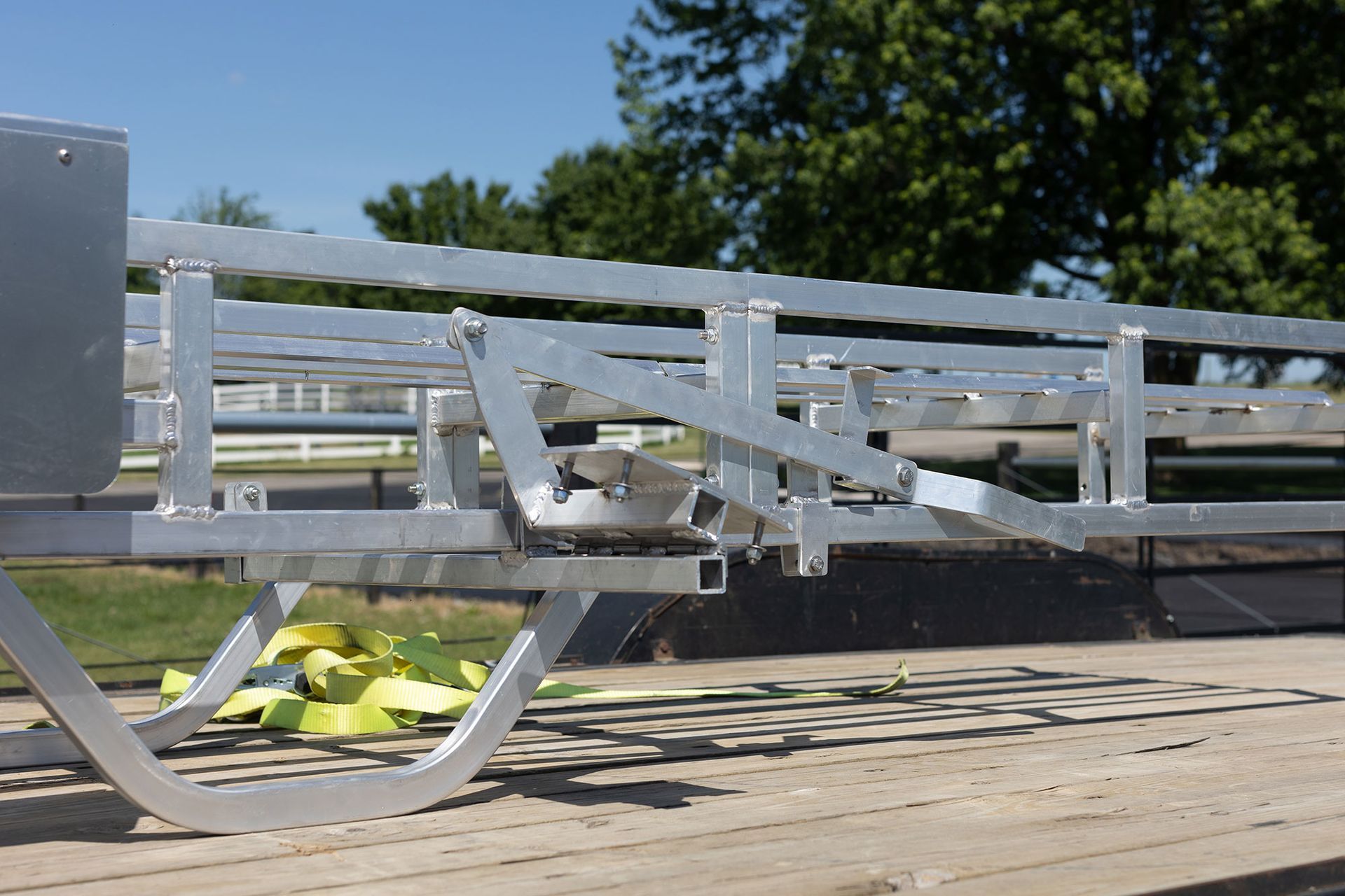 A metal structure is sitting on top of a wooden deck.
