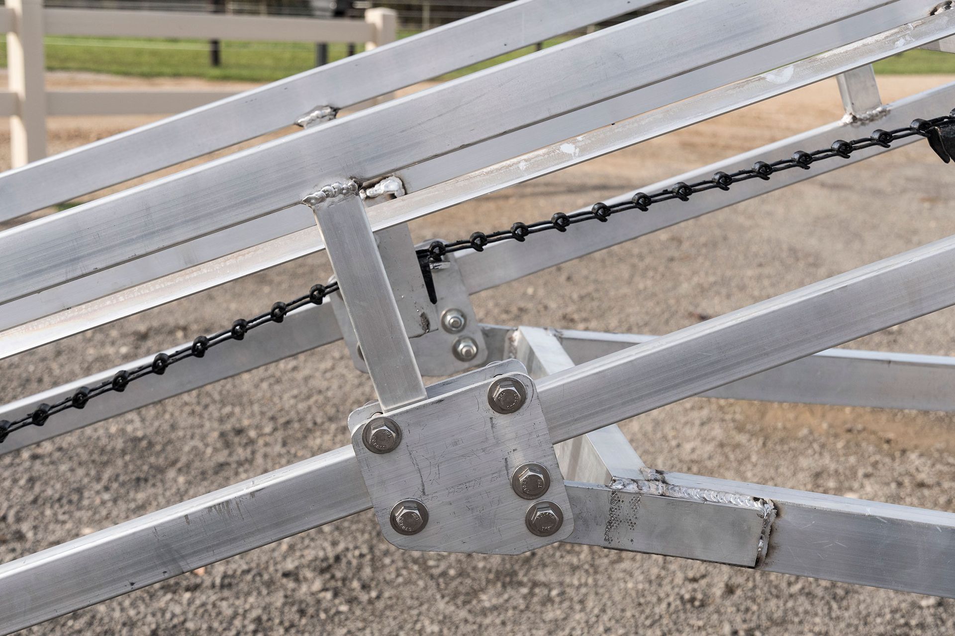 A close up of a metal structure with barbed wire attached to it.