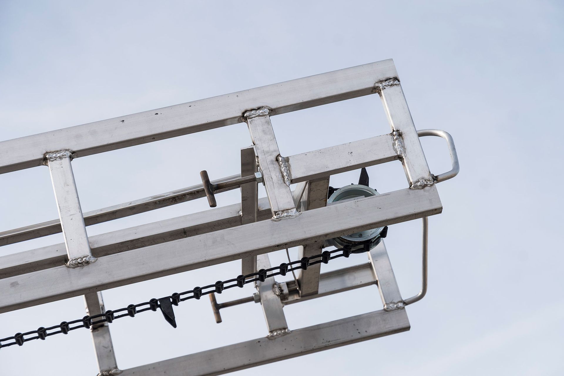 A stainless steel ladder with a chain attached to it