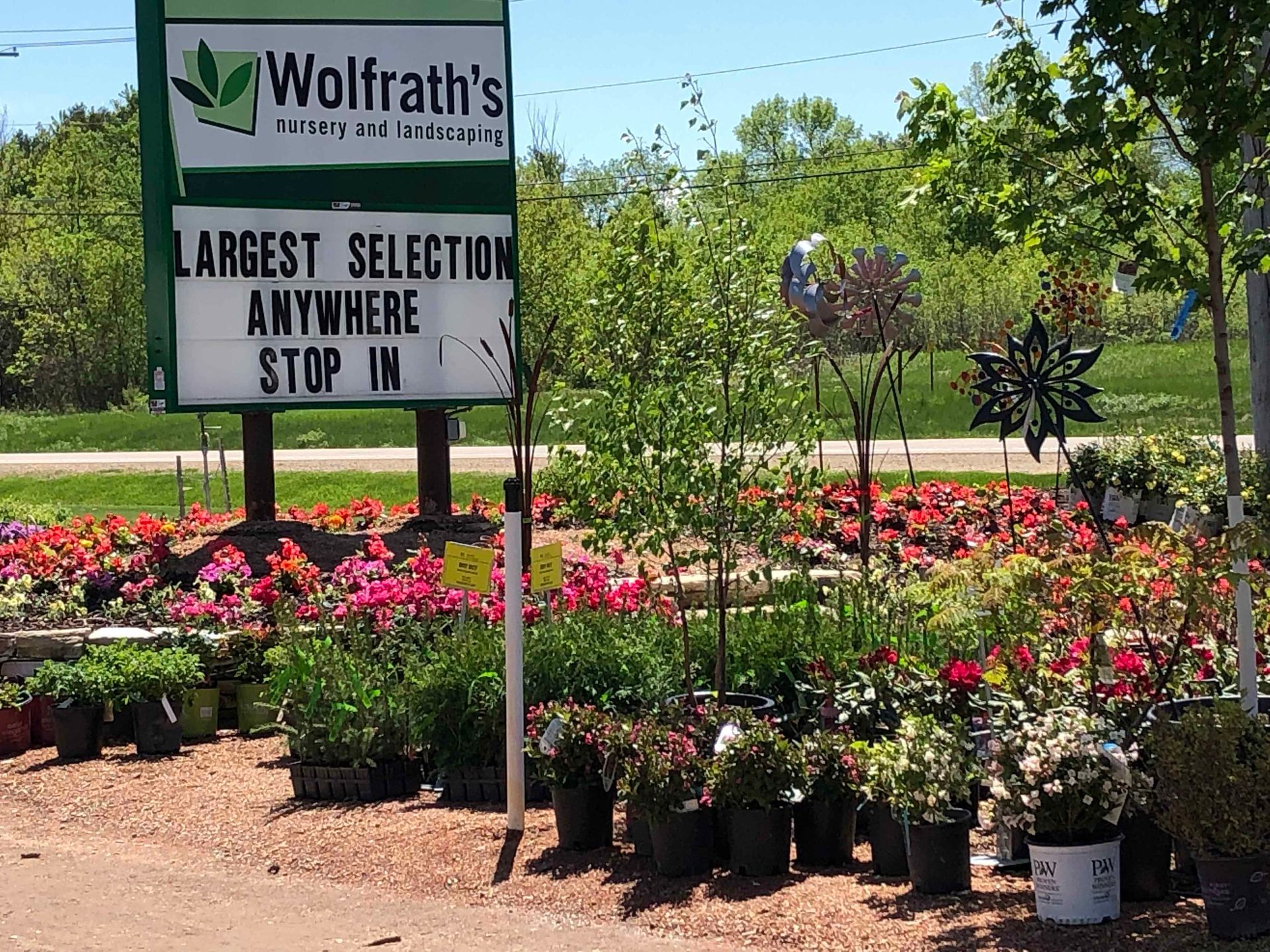 A sign that says wolfrath 's largest selection anywhere stop in