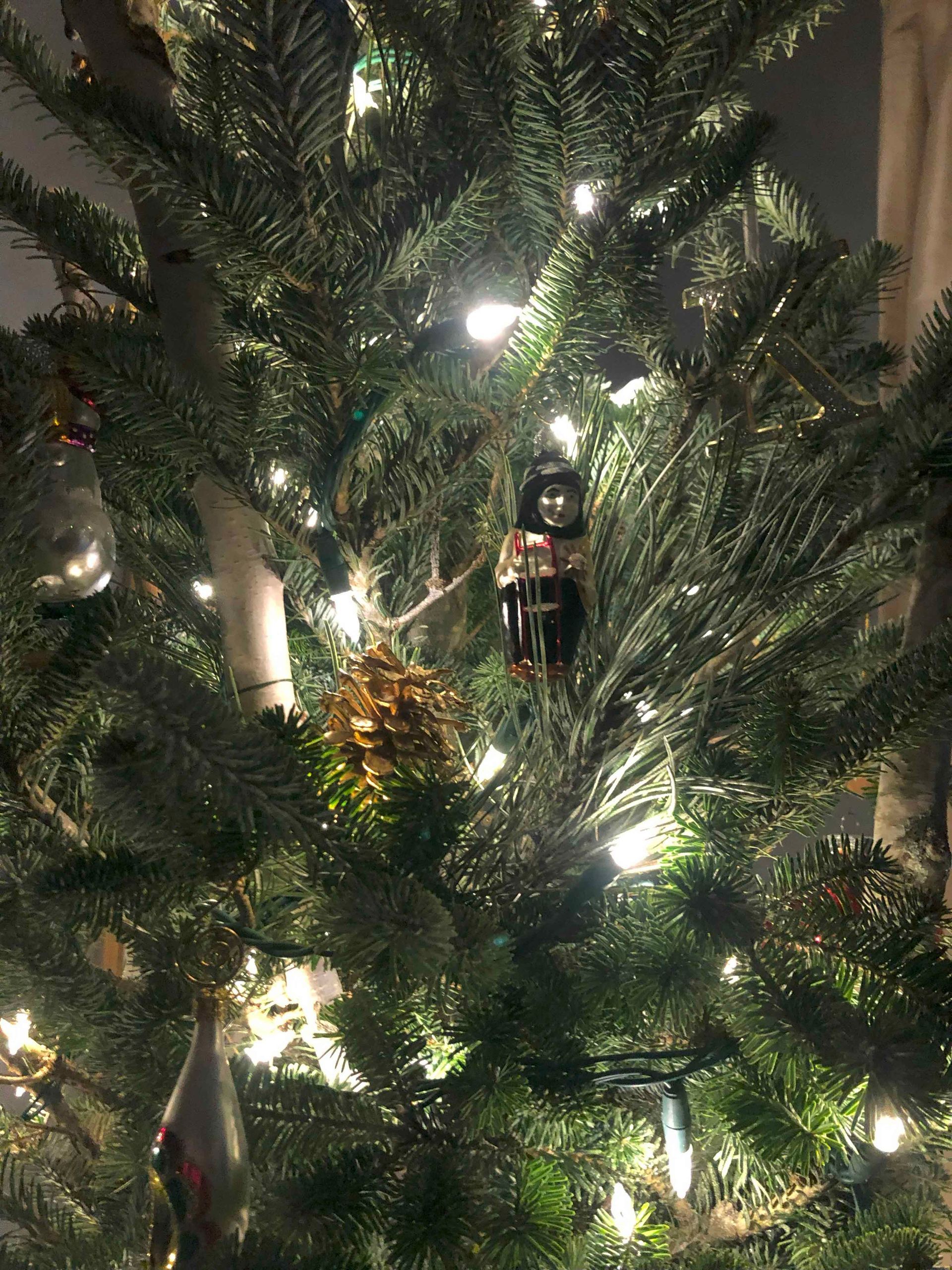 A close up of a christmas tree with lights and decorations.