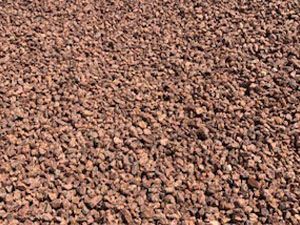 A pile of brown gravel is sitting on the ground.