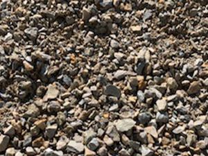 A pile of gravel is sitting on the ground.