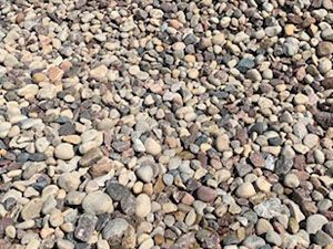 A pile of gravel is sitting on the ground.
