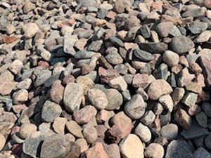 A pile of rocks sitting on top of each other on the ground.
