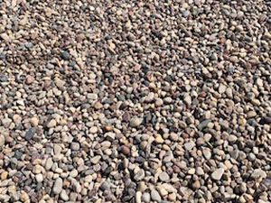 A pile of gravel is sitting on the ground.
