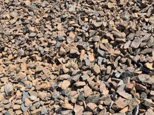 A pile of rocks is sitting on the ground.