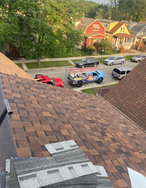 an aerial view of a roof with cars parked on it