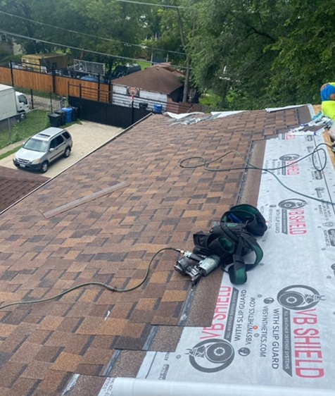 a  brown roof is being covered with a roof shingle