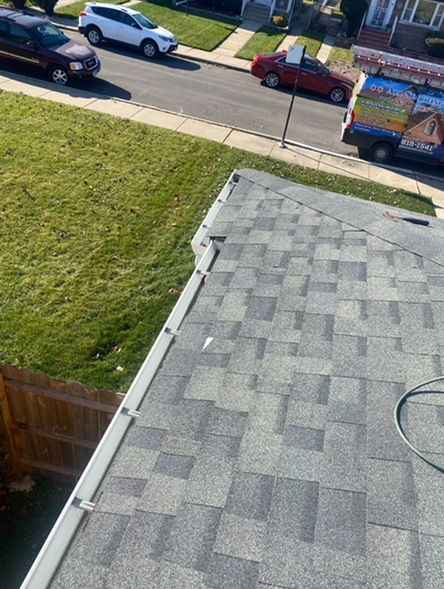 an aerial view of a roof with cars parked on the side of the road