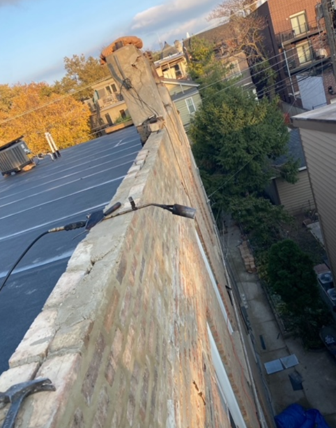 a person is standing on the side of a building