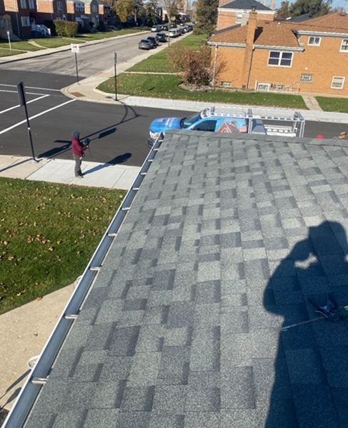 a shadow of a person is cast on the roof of a building