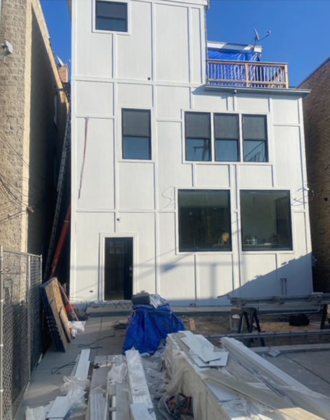 a white building with a balcony on top of it
