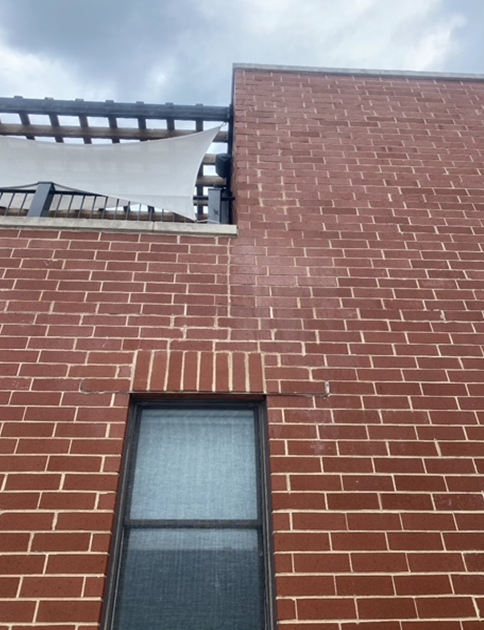 a brick building with a window and a balcony