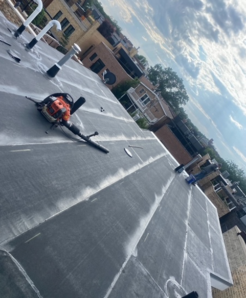 a blower is laying on the roof of a building