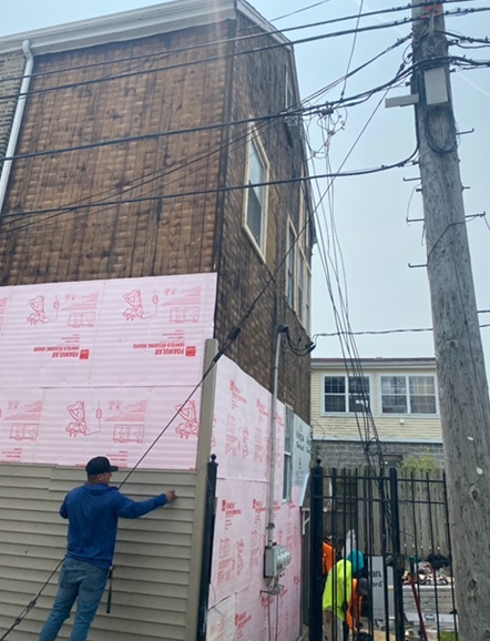 a man is working on the side of a building