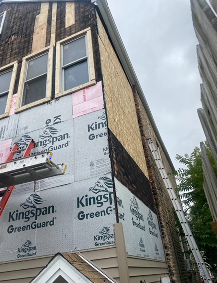a kingspan greenguard is being installed on the side of a building