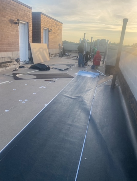 a group of people are working on the roof of a building