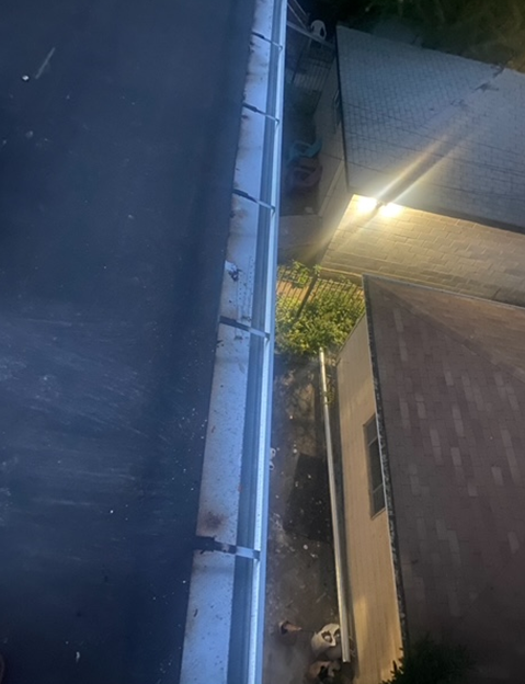 an aerial view of a gutter on the side of a building at night