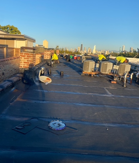 a group of people are working on the roof of a building