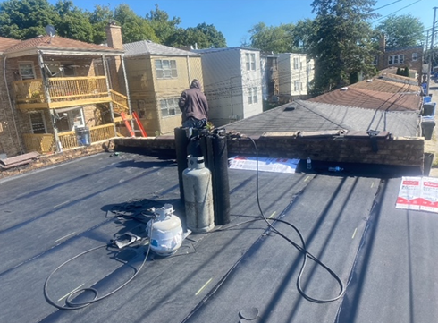 a man is working on the roof of a building