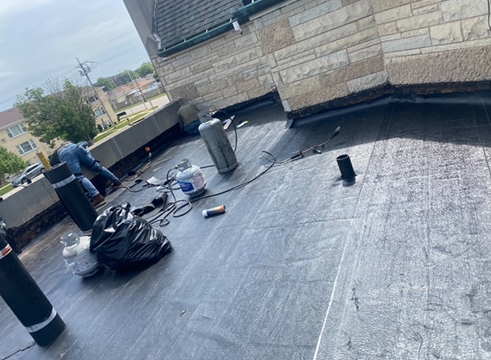 a man is working on a roof of a building