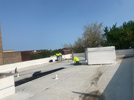 a group of people are working on a roof