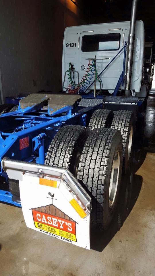 A casey 's restaurant truck is parked in a garage