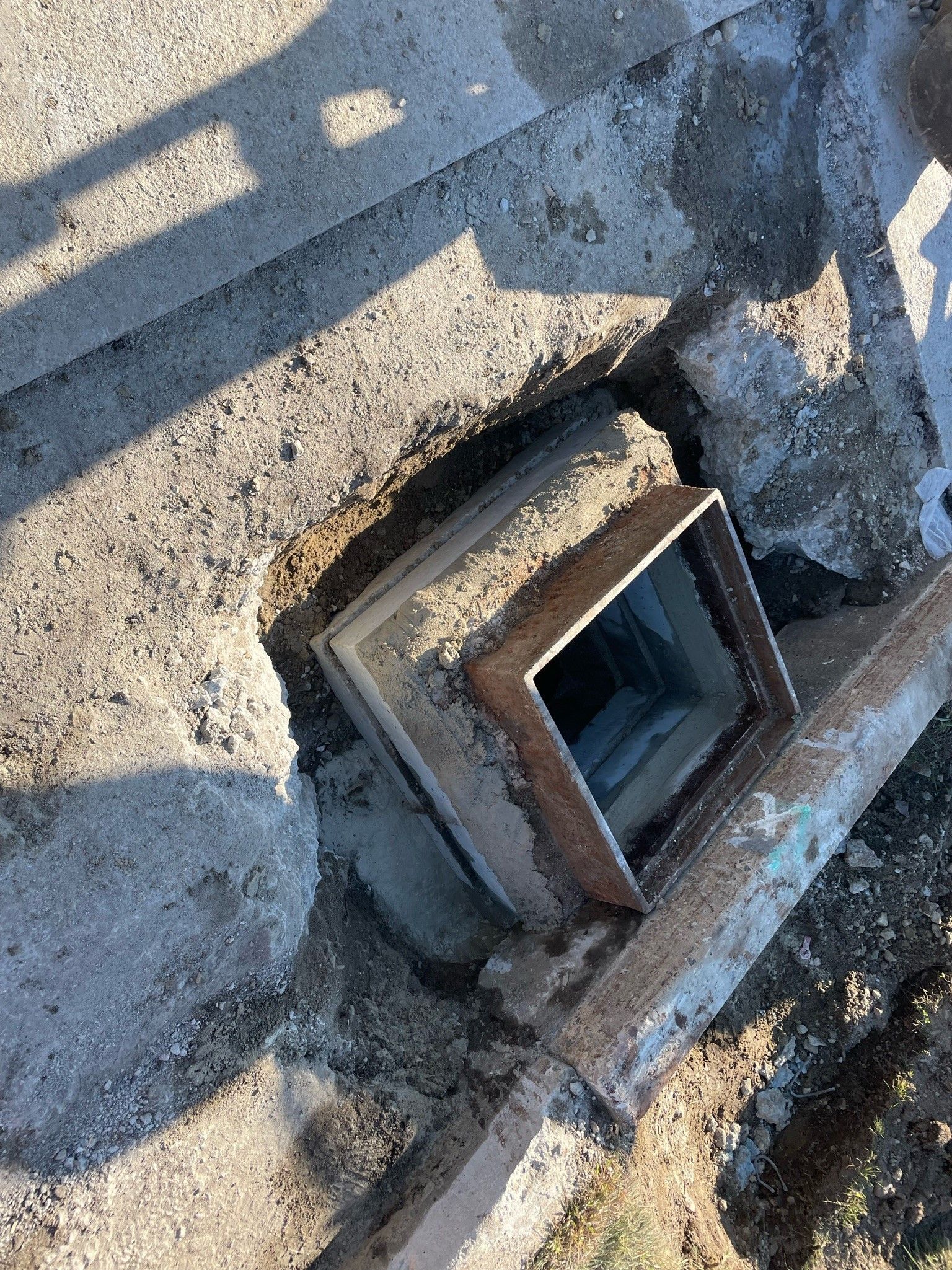 A piece of metal is sitting on top of a concrete surface.