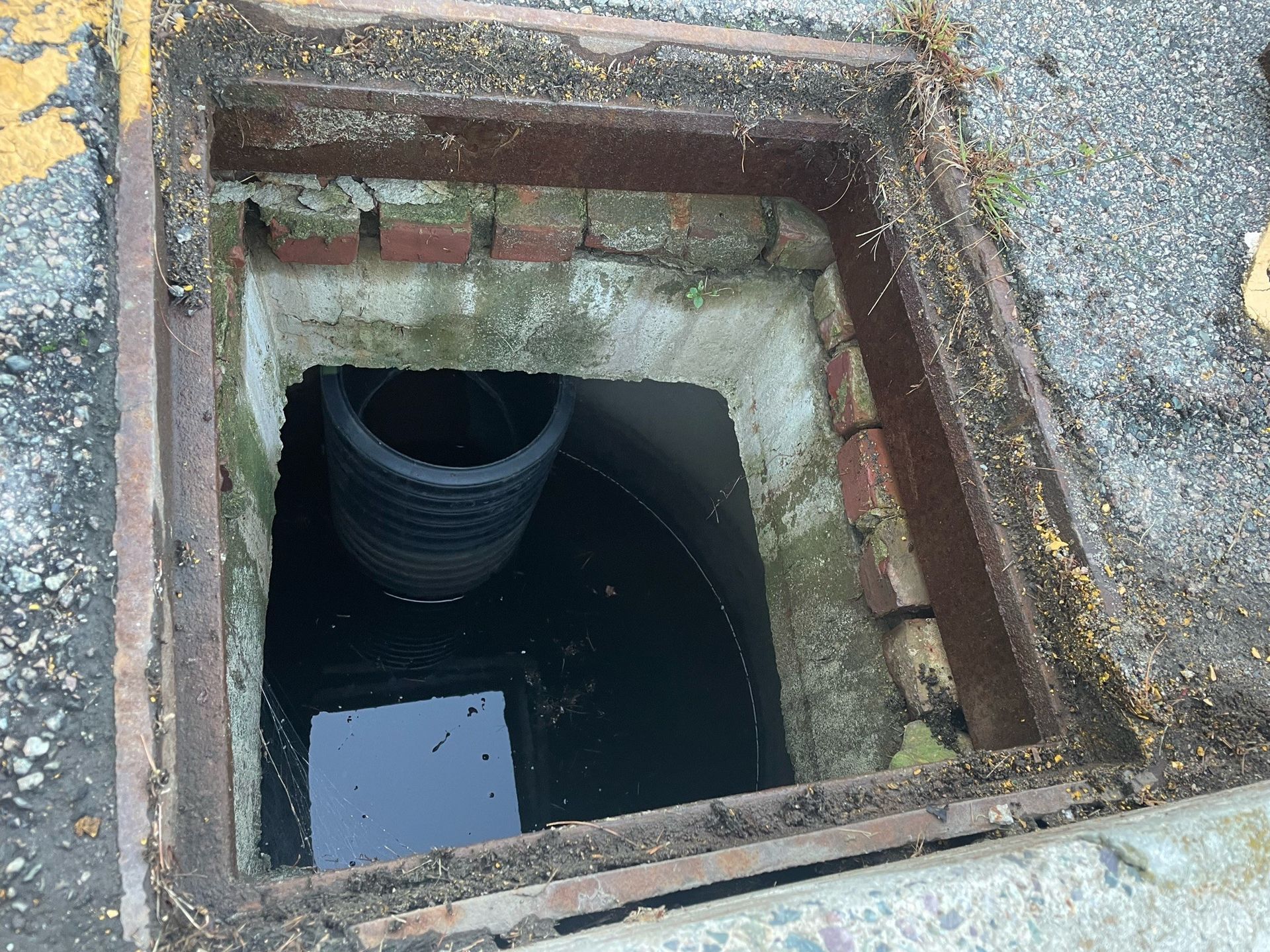 A manhole cover with water coming out of it