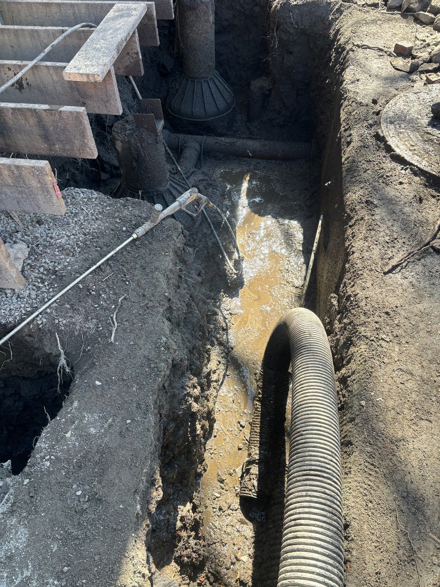 A hose is being installed in a hole in the ground.